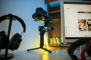 headphones and camera near monitor