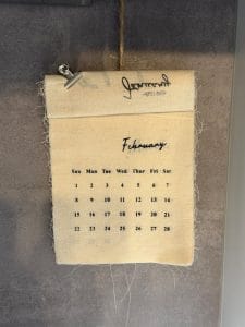 vintage fabric calendar displaying february dates for a content publishing calendar